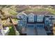 Aerial view of townhomes showing three units, small grass area, and three car garage at 1828 Blue Oak Ct, Castle Rock, CO 80104