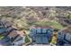 Aerial view of townhouses with lush landscaping, private yards, and proximity to natural hills and walking paths at 1828 Blue Oak Ct, Castle Rock, CO 80104