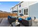 Backyard patio with outdoor seating, stone pavers, and a privacy fence at 1828 Blue Oak Ct, Castle Rock, CO 80104
