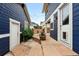 Backyard patio with pavers and seating, creating a charming outdoor space with a blue building facade and string lights at 3644 Wabash St, Denver, CO 80238