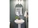 Stylish powder room featuring a pedestal sink, decorative mirror, modern fixtures, and textured wall at 3644 Wabash St, Denver, CO 80238