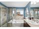 Bathroom featuring a separate shower and soaking tub with natural light from adjacent windows and a vanity sink at 3644 Wabash St, Denver, CO 80238