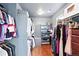 Walk-in closet with organized clothing racks, shelves, hardwood floor and built-in storage, offering ample space at 3644 Wabash St, Denver, CO 80238
