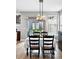 Dining area featuring modern light fixture and view of backyard, perfect for Gathering gatherings at 3644 Wabash St, Denver, CO 80238