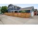 Charming two-story home with a wooden fence and partial garage, nestled in a desirable neighborhood at 3644 Wabash St, Denver, CO 80238