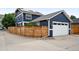 Beautiful home featuring a detached garage, with a unique wooden fence design, in a charming setting at 3644 Wabash St, Denver, CO 80238