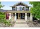 Charming two-story home boasts a welcoming front porch and beautiful landscaping, creating great curb appeal at 3644 Wabash St, Denver, CO 80238