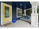 Cozy front porch features a swing and a vibrant yellow door, adding a pop of color to the home's entrance at 3644 Wabash St, Denver, CO 80238