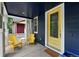 Relaxing front porch with yellow chairs and a small table provides a perfect spot for morning coffee at 3644 Wabash St, Denver, CO 80238