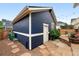Blue detached garage with stone path in the backyard, offering parking and additional storage at 3644 Wabash St, Denver, CO 80238