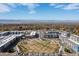 Aerial view of a Primary-planned community with green spaces, modern townhomes, and mountain views at 420 E Fremont Pl # 309, Centennial, CO 80122