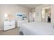 A bright bedroom with a queen bed, light walls, and a view into the ensuite bathroom and walk in closet at 420 E Fremont Pl # 309, Centennial, CO 80122