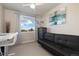 A cozy bedroom with a futon, neutral tones, and a window view offering natural light and an outdoor view at 420 E Fremont Pl # 309, Centennial, CO 80122