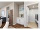 Open-concept entryway featuring sleek white cabinets, decor, and a view to the living room and laundry area at 420 E Fremont Pl # 309, Centennial, CO 80122