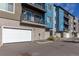 Apartment complex exterior showcasing private balconies and attached garages on a sunny day at 420 E Fremont Pl # 309, Centennial, CO 80122