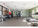A community gym offers a variety of equipment for a full workout with patterned accent wall at 420 E Fremont Pl # 309, Centennial, CO 80122
