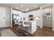 Modern kitchen with white cabinets, stainless steel appliances, a breakfast bar, and wood floors providing a welcoming culinary space at 420 E Fremont Pl # 309, Centennial, CO 80122