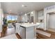 Modern kitchen with white cabinetry and a breakfast bar that leads to the spacious living area and balcony at 420 E Fremont Pl # 309, Centennial, CO 80122