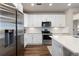 Well-lit kitchen features white cabinets, stainless steel appliances, subway tile backsplash, and generous counter space at 420 E Fremont Pl # 309, Centennial, CO 80122