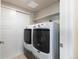 A well-equipped laundry room features modern appliances and ample storage with double doors at 420 E Fremont Pl # 309, Centennial, CO 80122