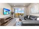 Comfortable living room with wood floors, a view, a gray couch, a flat screen television and tasteful decor at 420 E Fremont Pl # 309, Centennial, CO 80122