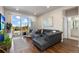 Relaxing living space with gray sofa, balcony access, mounted TV, and stylish decor providing a welcoming and comfortable ambiance at 420 E Fremont Pl # 309, Centennial, CO 80122