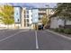 Apartment complex parking area with EV charging stations and designated accessible parking space at 420 E Fremont Pl # 309, Centennial, CO 80122