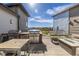 Spacious outdoor patio with a built-in grill, dining table, fire pit, and seating area at 420 E Fremont Pl # 309, Centennial, CO 80122