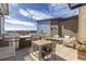 Outdoor patio area with stainless steel grill, fire pit, dining table, seating, and city view at 420 E Fremont Pl # 309, Centennial, CO 80122