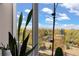 A picturesque window view capturing lush foliage, distant mountains, and a blue sky with scattered clouds at 420 E Fremont Pl # 309, Centennial, CO 80122