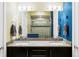 Bathroom with double sinks, granite countertops, and updated shower at 2432 Champa St, Denver, CO 80205