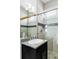 Bathroom featuring a granite-topped vanity and glass-enclosed shower with decorative tile accents at 2432 Champa St, Denver, CO 80205