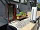 Charming patio area with a planter box, patterned tiles, and stylish outdoor decor at 2432 Champa St, Denver, CO 80205