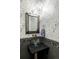 Chic powder room featuring decorative wallpaper, a unique sink, and modern fixtures at 2432 Champa St, Denver, CO 80205