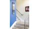 Contemporary staircase with modern railing and artwork on the walls at 2432 Champa St, Denver, CO 80205