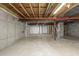 Open unfinished basement with visible beams and concrete foundation, offering ample space for finishing at 22163 E Calhoun Pl, Aurora, CO 80016