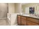 Bathroom vanity featuring rich wood cabinetry, a sink, and a large mirror at 22163 E Calhoun Pl, Aurora, CO 80016