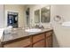 Bathroom vanity with modern countertop, sink, large mirror, and ample storage space at 22163 E Calhoun Pl, Aurora, CO 80016
