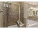 Beautiful tiled shower featuring a built-in seat and a glass door, next to a tub at 22163 E Calhoun Pl, Aurora, CO 80016