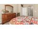 Bedroom with a classic wood dresser, chair, and a cozy quilt on the bed at 22163 E Calhoun Pl, Aurora, CO 80016