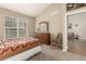 A bright bedroom with vaulted ceiling and large window featuring a dresser and rocking chair at 22163 E Calhoun Pl, Aurora, CO 80016