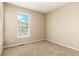 Bright bedroom featuring neutral walls, plush carpeting, and a window view at 22163 E Calhoun Pl, Aurora, CO 80016