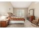 Well-lit bedroom showcasing a window, classic dresser, and traditional quilt on the bed at 22163 E Calhoun Pl, Aurora, CO 80016