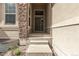 Inviting entryway with stone accents, leading to a stylish door and a welcoming ambiance at 22163 E Calhoun Pl, Aurora, CO 80016
