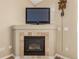 A cozy fireplace with tile surround and mounted TV offers a comfortable focal point in this home at 22163 E Calhoun Pl, Aurora, CO 80016