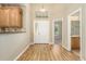 Bright foyer featuring wood floors, a white door, and easy access to other rooms in the house at 22163 E Calhoun Pl, Aurora, CO 80016