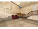 Garage with a staircase to above, ample storage space, work table and a seating area at 22163 E Calhoun Pl, Aurora, CO 80016