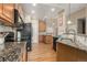 This kitchen features stainless steel appliances, granite counters, and wood cabinets, creating a clean and modern space at 22163 E Calhoun Pl, Aurora, CO 80016