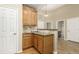 A modern kitchen featuring granite counters and wood cabinets, is conveniently located near a bathroom at 22163 E Calhoun Pl, Aurora, CO 80016