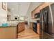 The kitchen features stainless steel appliances, granite counters, and wood cabinets, open to the living area at 22163 E Calhoun Pl, Aurora, CO 80016